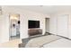 Relaxing bedroom with a modern TV stand and a view to the vintage-tiled bathroom at 1801 Vine St, Leesburg, FL 34748