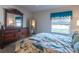 Main bedroom with a large bed, dresser, and mirror at 1836 Madero Dr, The Villages, FL 32159