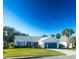 Charming single story home with a two-car garage and well-manicured lawn at 1836 Madero Dr, The Villages, FL 32159