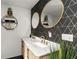Modern bathroom with double vanity, stylish wallpaper, and gold accents at 26650 Pelican St, Eustis, FL 32736