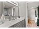 Bathroom with marble countertop and gray cabinets at 26650 Pelican St, Eustis, FL 32736