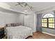 Bright bedroom with large window, ceiling fan and hardwood floors at 26650 Pelican St, Eustis, FL 32736
