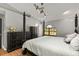 Main bedroom with large four-poster bed and hardwood floors at 26650 Pelican St, Eustis, FL 32736