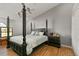 Main bedroom with large four-poster bed and hardwood floors at 26650 Pelican St, Eustis, FL 32736