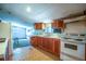 Simple kitchen with wood cabinets, stove, and refrigerator at 26650 Pelican St, Eustis, FL 32736