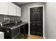 Laundry room with washer, dryer, and overhead cabinets at 26650 Pelican St, Eustis, FL 32736