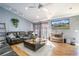 Spacious living room featuring hardwood floors, comfortable leather furniture, and a large TV at 26650 Pelican St, Eustis, FL 32736