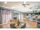 Open concept living area with hardwood floors, a modern kitchen, and breakfast bar at 26650 Pelican St, Eustis, FL 32736