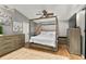 Bright bedroom with a canopy bed, wood floors, and ample closet space at 26650 Pelican St, Eustis, FL 32736