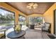Covered patio with comfortable seating and a fire pit, perfect for relaxing outdoors at 26650 Pelican St, Eustis, FL 32736