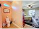 Guest bathroom with toilet and access to bedroom at 27103 Camerons Run, Leesburg, FL 34748