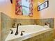 Soaking tub with tile surround and window at 27103 Camerons Run, Leesburg, FL 34748