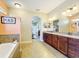 Primary bathroom with double vanity, garden tub, and walk-in shower at 27103 Camerons Run, Leesburg, FL 34748