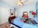 Bright bedroom with ceiling fan and double bed at 27103 Camerons Run, Leesburg, FL 34748