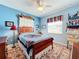 Cozy bedroom with antique wooden bed and blue walls at 27103 Camerons Run, Leesburg, FL 34748