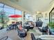 Enclosed patio with red umbrella and seating area at 27103 Camerons Run, Leesburg, FL 34748