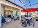 Screened-in patio with seating and dining areas at 27103 Camerons Run, Leesburg, FL 34748