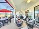 Covered patio with wicker furniture and dining set at 27103 Camerons Run, Leesburg, FL 34748