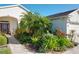 Landscaped front yard with walkway and lush greenery at 27103 Camerons Run, Leesburg, FL 34748