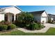 Landscaped front yard with palm tree and walkway at 27103 Camerons Run, Leesburg, FL 34748