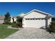 Two car garage with brick paved driveway at 27103 Camerons Run, Leesburg, FL 34748
