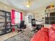 Home office with built-in shelving and a red couch at 27103 Camerons Run, Leesburg, FL 34748