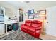 Home office with red leather couch and ample storage at 27103 Camerons Run, Leesburg, FL 34748