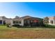 Back exterior view showing home and screened patio at 27103 Camerons Run, Leesburg, FL 34748