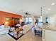 Relaxing living room with an orange accent wall and access to a patio at 27103 Camerons Run, Leesburg, FL 34748