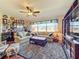 Comfortable living room with built in bar, hardwood floors, and lots of light at 27103 Camerons Run, Leesburg, FL 34748