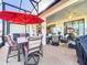Relaxing screened patio with table, chairs, and umbrella at 27103 Camerons Run, Leesburg, FL 34748