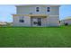 Spacious backyard featuring a covered patio and lush green lawn at 2833 Supermarine Rd, Tavares, FL 32778