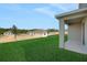 A view from the covered patio looking out to the graded lawn at 2833 Supermarine Rd, Tavares, FL 32778