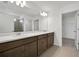 Spacious bathroom features double vanity, large mirror and tile flooring at 2833 Supermarine Rd, Tavares, FL 32778