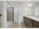 Modern bathroom with glass shower, double vanity and tile floors at 2833 Supermarine Rd, Tavares, FL 32778
