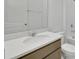 A modern bathroom featuring a large mirror, white countertops and a coordinated neutral vanity at 2833 Supermarine Rd, Tavares, FL 32778