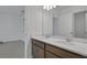 Bathroom with dual sinks, quartz countertop, and wood cabinets at 2833 Supermarine Rd, Tavares, FL 32778