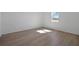 Bedroom with wood floors, white walls, and a window at 2833 Supermarine Rd, Tavares, FL 32778