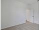 A cozy bedroom features neutral carpet, white walls, and an open doorway leading to a bright space at 2833 Supermarine Rd, Tavares, FL 32778