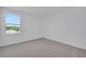 Empty bedroom with neutral carpet and bright window at 2833 Supermarine Rd, Tavares, FL 32778