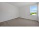 Neutral bedroom with light-filled window at 2833 Supermarine Rd, Tavares, FL 32778