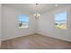 Bright dining room with wood floors, chandelier, and large windows at 2833 Supermarine Rd, Tavares, FL 32778