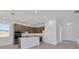 Modern kitchen with an island, stainless appliances, and wood-look floors at 2833 Supermarine Rd, Tavares, FL 32778