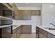 Kitchen featuring stainless steel appliances, wood cabinets, and white countertops at 2833 Supermarine Rd, Tavares, FL 32778