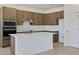 Modern kitchen features an island, stainless steel appliances, and stylish wood cabinetry at 2833 Supermarine Rd, Tavares, FL 32778
