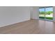Open-concept living room with wood floors and sliding glass doors leading to backyard at 2833 Supermarine Rd, Tavares, FL 32778