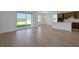 Spacious open floorplan living room with a kitchen and large sliding glass doors at 2833 Supermarine Rd, Tavares, FL 32778