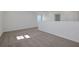 Loft area with carpet, white walls, and a window at 2833 Supermarine Rd, Tavares, FL 32778