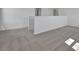 Loft area with carpet, white walls, and a railing at 2833 Supermarine Rd, Tavares, FL 32778