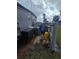 A house's backyard features an air conditioner, a utility box, rocks, and some weeds at 30 Riverview Dr, Fruitland Park, FL 34731